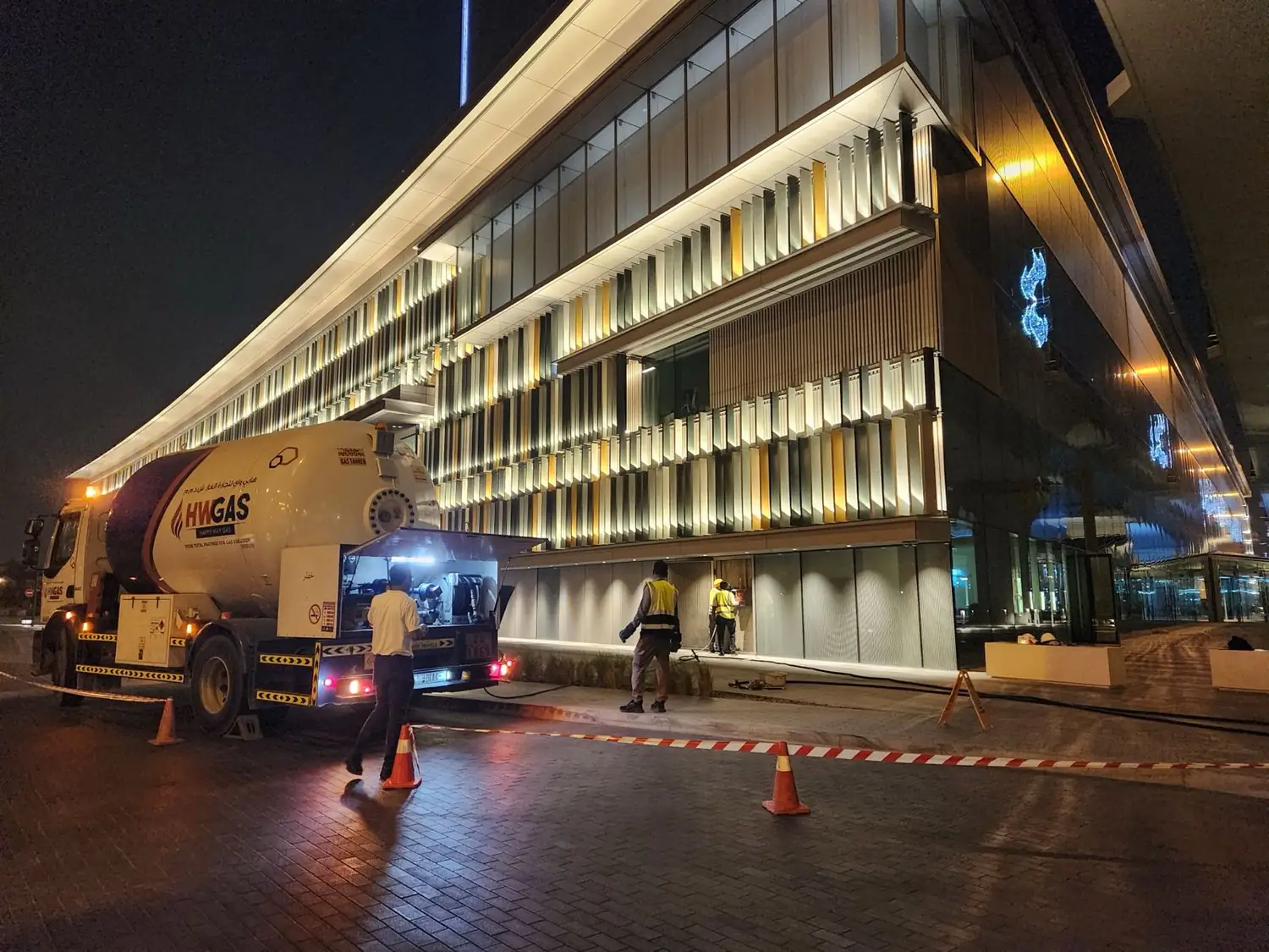 Petrosafe bulk LPG tanker filling a building at night